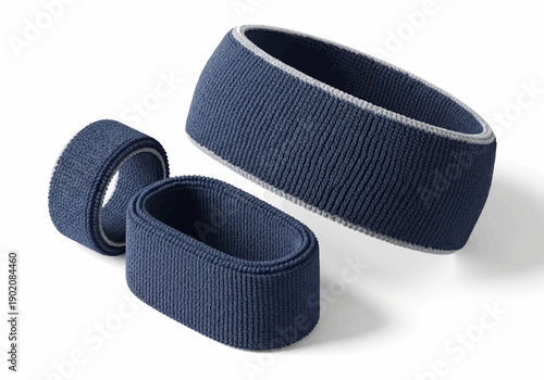 Navy blue fabric bracelets of varying sizes arranged on a white surface with subtle shadows