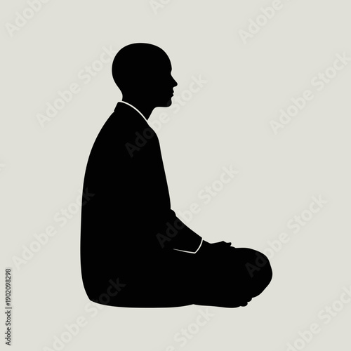 Black silhouette of a man sitting in a meditative pose isolated on light gray background