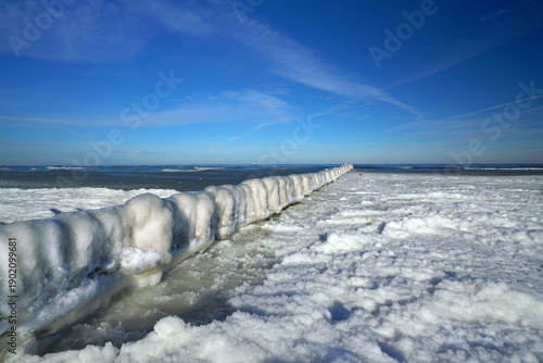 silence in winter, frozen wooden groynes at the sea in winter	
