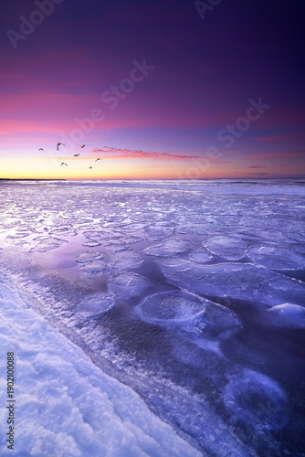 unique frozen ice floes in sunset light on the natural Baltic Sea coast