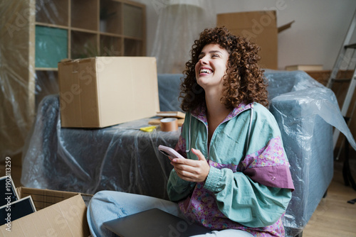 Happy woman relaxing while moving into a new home
