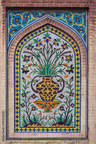 Vertical kashi-kari or faience tile mosaic floral panel on ancient mughal era Wazir Khan mosque in Lahore walled city, Punjab, Pakistan