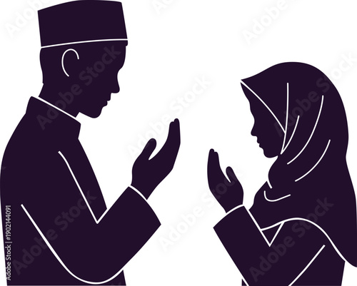 Muslim man and woman praying together in silhouette