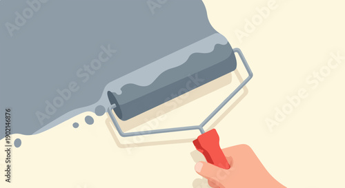 Hand holding a paint roller applying gray paint to a light-colored wall