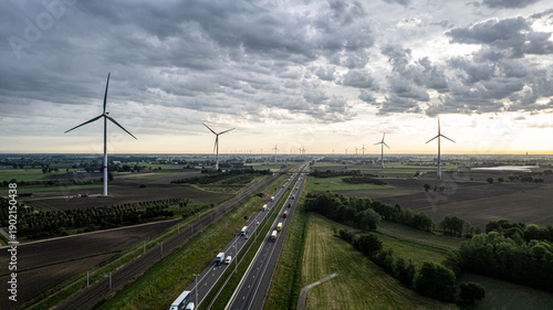 Aerial view of wind turbines and highway in rural Belgium countryside, renewable energy and sustainable infrastructure concept
