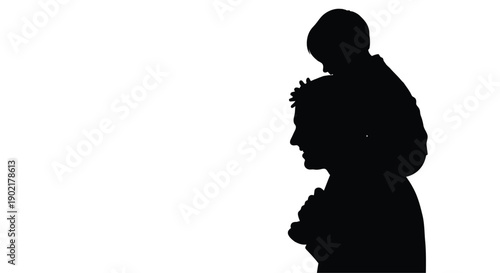 Silhouette of a father carrying a child on his shoulders