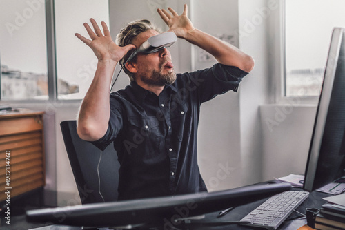 Graphic designer wearing VR glasses, sticking tongue out, mocking mischieviously