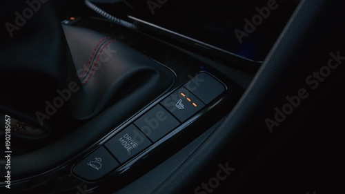 Close up video of a driver pressing the heated seat control button inside a modern car, highlighting comfort technology and premium vehicle features for automotive marketing, lifestyle content, and wi