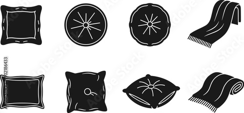 Collection of decorative pillows and folded blankets in a simple black and white graphic style