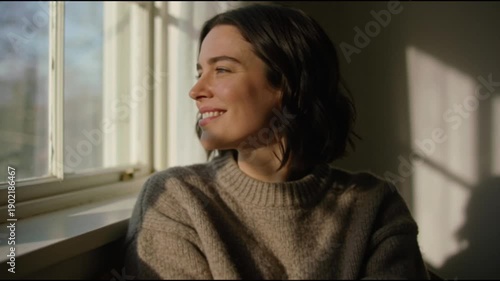 Wallpaper Mural Video of young woman in cashmere sweater looking out the window smiling Torontodigital.ca