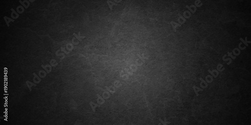 Dark charcoal grunge wall texture background. Dark black rough grunge surface with smoke edge. Black texture chalk board and black board.