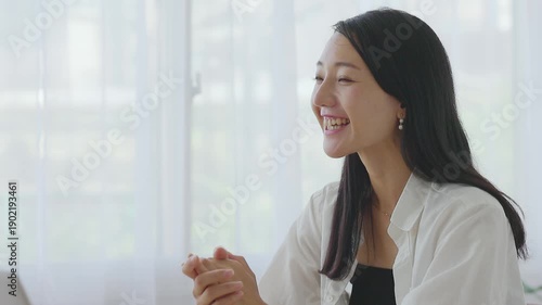 Smiling Woman Talking at Desk During Casual Meeting