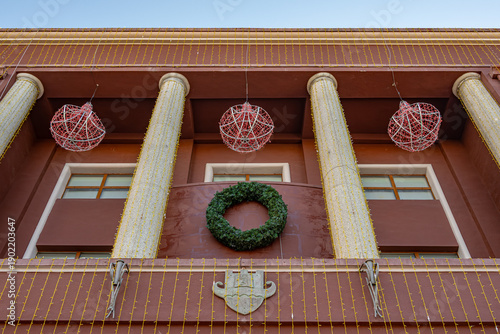 Christmas wreath on city hall facade in Durrës.
Festive public decoration concept. Copy space.