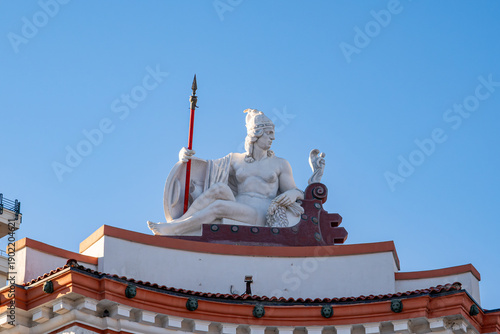 Queen Teuta statue on a historic building in Durrës.
Cultural heritage and cityscape concept. Copy space.