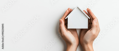 Cozy home protection hands minimalist house model white background safe shelter concept care security support comfort clean design