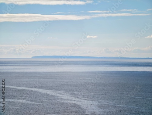 Εκτύπωση καμβά Serene scene depicting layered cloud formations over placid sea with subtle past