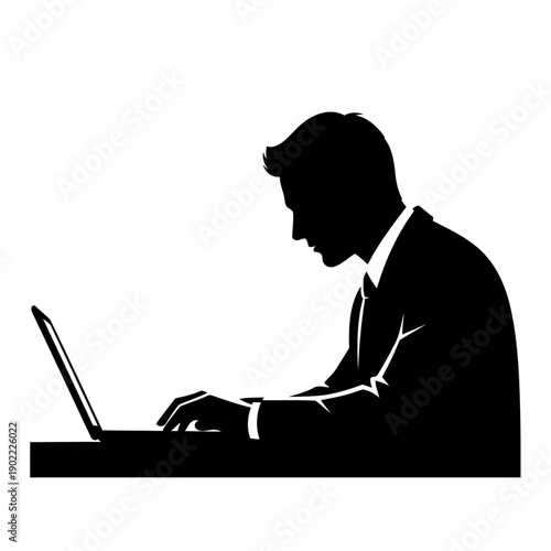 A silhouette of a businessman working on his laptop at a desk