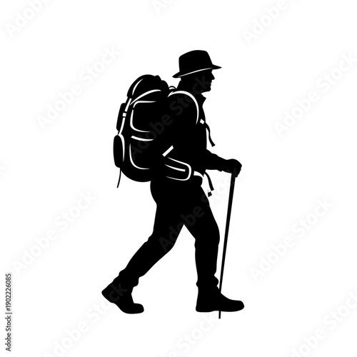 A silhouette of a hiker walking with a backpack and trekking pole