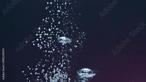 Underwater Ascent A steady stream of small, luminous bubbles rising gracefully through clear, deep blue water, catching and refracting ambient light from above. Focus on the upward motion and clarity.
