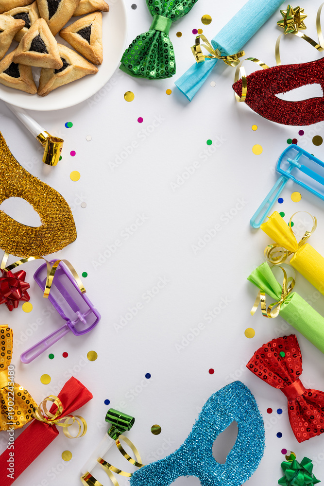 Fototapeta premium Vibrant vertical Purim tableau featuring glitter masks, bright ribbons, a blue noisemaker, wrapped gifts, scattered confetti, and plate of hamantaschen cookies
