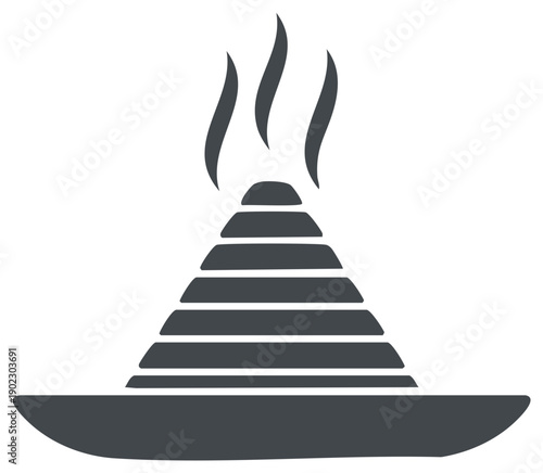 Fragrant incense cone generating smoke on a ceremonial holder for aromatherapy