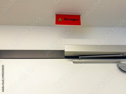 X-ray-sign above an entrance door to a radiology department in a hospital.