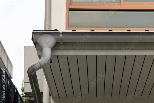 Bilde på lerret white plastic rain gutter with house background