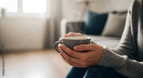 Wallpaper Mural Close-up of a person holding a cup of hot coffee near a window, soft morning light, cozy atmosphere, minimalistic home interior Torontodigital.ca
