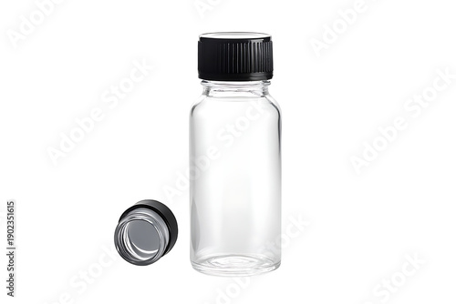 A clear glass bottle with a black cap on a black background