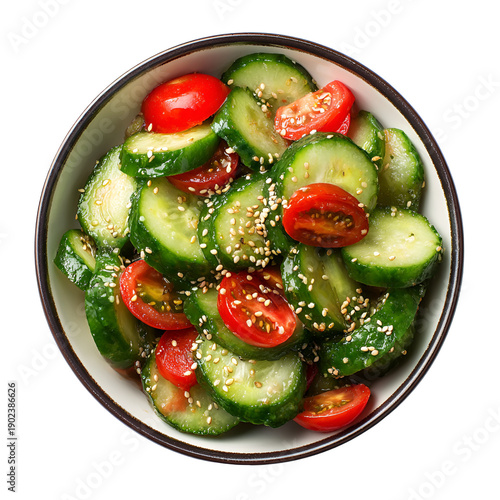 Fresh cucumber and tomato salad with sesame seeds in a bowl