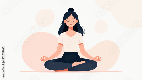 A woman is sitting cross legged and meditating. She is smiling and she is in a peaceful state of mind