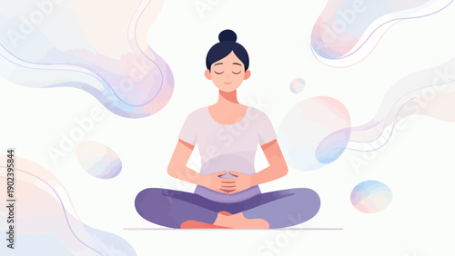 A woman is sitting cross legged on a mat with her hands on her stomach. She is in a relaxed state of mind