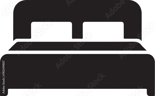 Black and white bed with two pillows and headboard