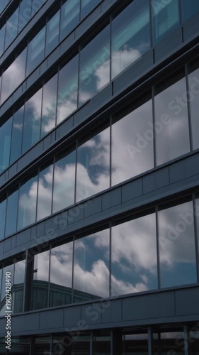 corporate office exterior with large reflective glass panels and dark metal frames
