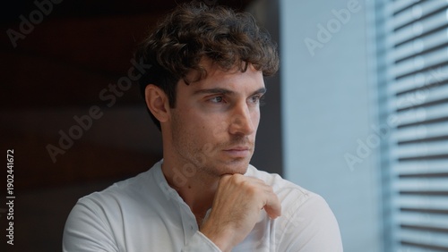 Slika na platnu Portrait thinking Caucasian business man looking in window think contemplate puz