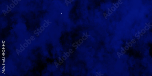 Artificial magic smoke in black and blue light on black background in darkness. light blue and dark blue background. Black and blue Grunge Concrete Wall Texture Background.