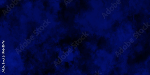 Artificial magic smoke in black and blue light on black background in darkness. light blue and dark blue background. Black and blue Grunge Concrete Wall Texture Background.