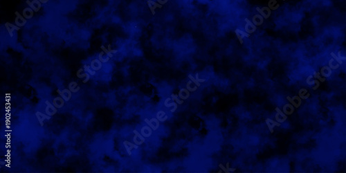 Artificial magic smoke in black and blue light on black background in darkness. light blue and dark blue background. Black and blue Grunge Concrete Wall Texture Background.
