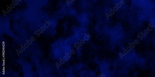 Artificial magic smoke in black and blue light on black background in darkness. light blue and dark blue background. Black and blue Grunge Concrete Wall Texture Background.