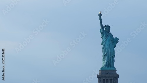 Iconic statue of liberty standing tall over new york city skyline symbolizing freedom, hope, and democracy under a clear blue sky