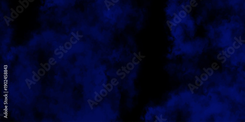 Artificial magic smoke in black and blue light on black background in darkness. light blue and dark blue background. Black and blue Grunge Concrete Wall Texture Background.