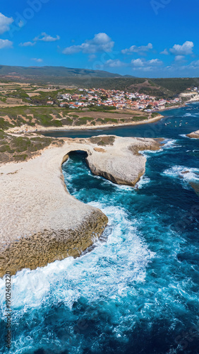 Stunning aerial view of the natural limestone arch at S'Archittu, Sardinia, Italy