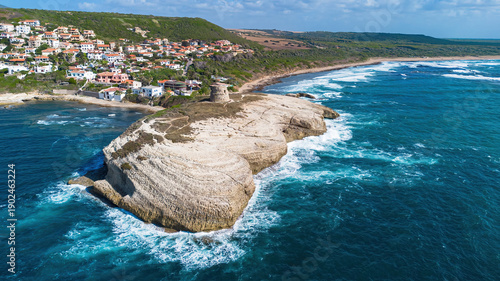 Aerial view of an ancient stone watchtower on the white cliffs of S'Archittu, Sardinia, Italy
