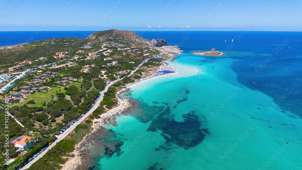 Fototapeta premium Crystal clear turquoise waters and white sands of Spiaggia La Pelosa from above in Sardinia, Italy