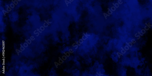 Artificial magic smoke in black and blue light on black background in darkness. light blue and dark blue background. Black and blue Grunge Concrete Wall Texture Background.