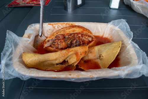 Obraz na plátně Traditional Mexican torta ahogada with tacos dorados in red chili sauce on a pla