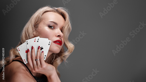 Sophisticated Woman Displaying Confidence. Refined Lady With Vibrant Nail Polish And Playing Cards. Chic Blonde Woman Confidently Posing With Red Nails And Winning Poker Hand In Lavish Setting