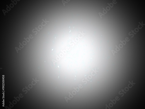 A simple abstract background with a bright central light source fading to a dark vignette border. Small, subtle speckles float around the glow, suggesting dust particles or distant stars in space.
