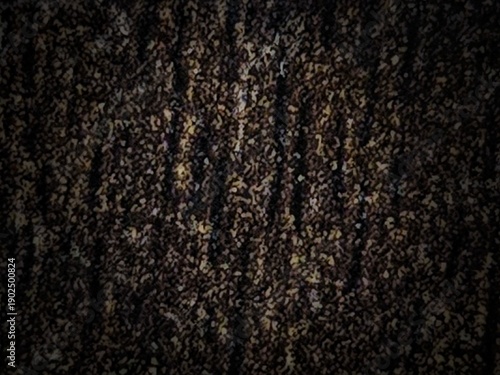A dark, coarse, heavily textured fabric or surface. The material features a dense, uneven weave in deep browns and blacks, interspersed with small, irregular flecks of beige, creating a rough, gritty 