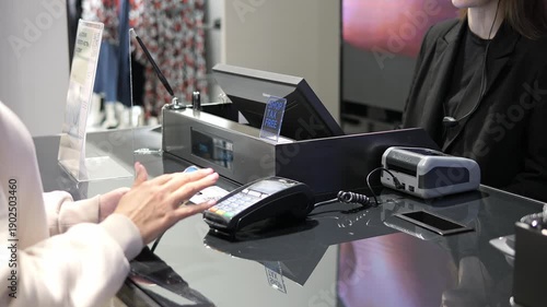 Contactless payment by smartphone at checkout payment process shows modern retail lifestyle Young customer making payment secure payment technology improves shopping convenience store evening scene